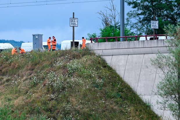 SNCF employees repair the scene of a suspected attack on the Eastern high speed railway network in Vandieres, north eastern France on July 26, 2024, as France's high-speed rail network was hit by an attack disrupting the transport system, hours before the opening ceremony of the Paris 2024 Olympic Games. According to the French railway company SNCF, a massive attack on a large scale hit the high speed train network (TGV) on July 26, 2024, and many routes will have to be cancelled. The SNCF urged passengers to postpone their trips and stay away from train stations. (Photo by Jean-Christophe VERHAEGEN / AFP) (Photo by JEAN-CHRISTOPHE VERHAEGEN/AFP via Getty Images)