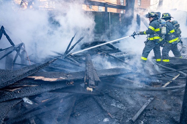 A two-alarm fire ripped through multiple commercial buildings on Woodhaven Blvd. in Middle Village, Queens on Saturday, Nov. 30, 2024. (Theodore Parisienne / New York Daily News)