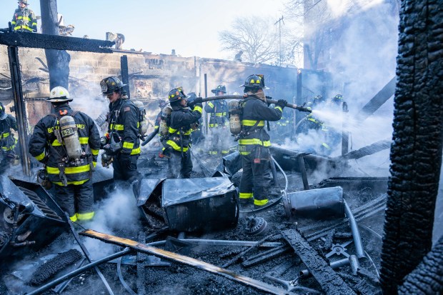 A two-alarm fire ripped through multiple commercial buildings on Woodhaven Blvd. in Middle Village, Queens on Saturday, Nov. 30, 2024. (Theodore Parisienne / New York Daily News)