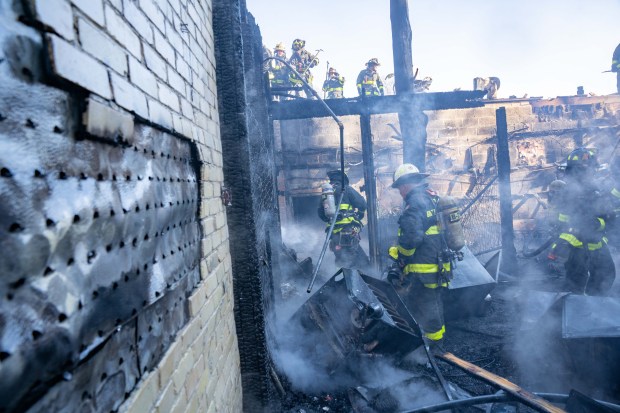 A two-alarm fire ripped through multiple commercial buildings on Woodhaven Blvd. in Middle Village, Queens on Saturday, Nov. 30, 2024. (Theodore Parisienne / New York Daily News)