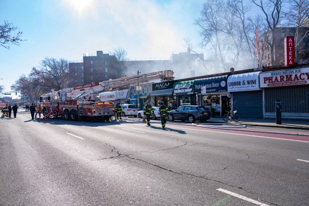 A two-alarm fire ripped through multiple commercial buildings on Woodhaven Blvd. in Middle Village, Queens on Saturday, Nov. 30, 2024. (Theodore Parisienne / New York Daily News)