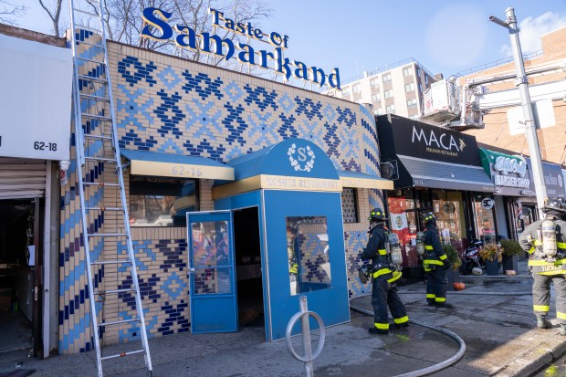 A two-alarm fire ripped through multiple commercial buildings on Woodhaven Blvd. in Middle Village, Queens on Saturday, Nov. 30, 2024. (Theodore Parisienne / New York Daily News)