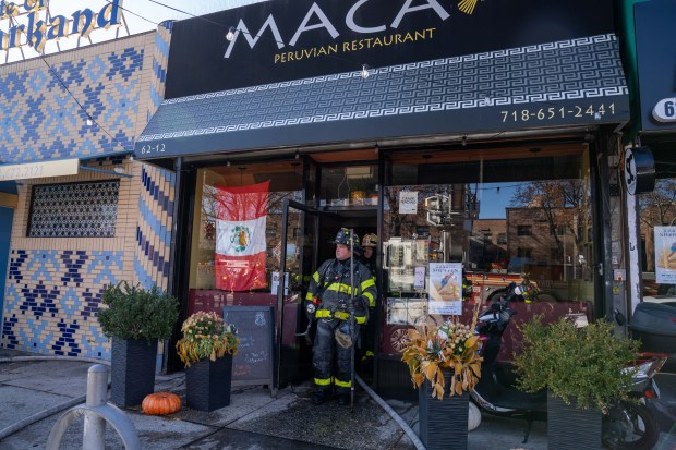 A two-alarm fire ripped through multiple commercial buildings on Woodhaven Blvd. in Middle Village, Queens on Saturday, Nov. 30, 2024. (Theodore Parisienne / New York Daily News)