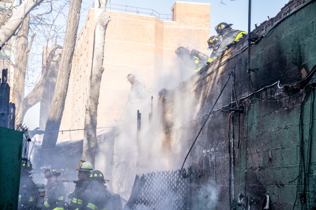 A two-alarm fire ripped through multiple commercial buildings on Woodhaven Blvd. in Middle Village, Queens on Saturday, Nov. 30, 2024. (Theodore Parisienne / New York Daily News)